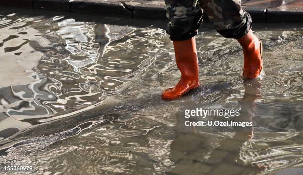 in the flood water - rubber boots stock pictures, royalty-free photos & images