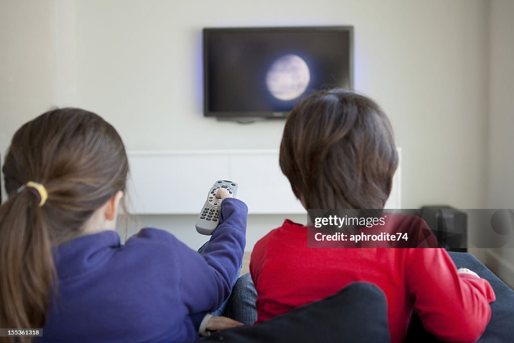 Children changing the television channel