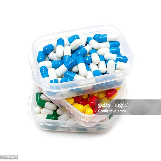 capsules in pill box isolated on white background - messy medicine cabinet stock pictures, royalty-free photos & images