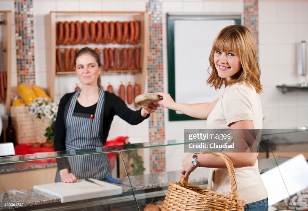 Woman in butchers shop