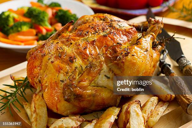 roast chicken dinner, topped with thyme - roast potatoes stock pictures, royalty-free photos & images