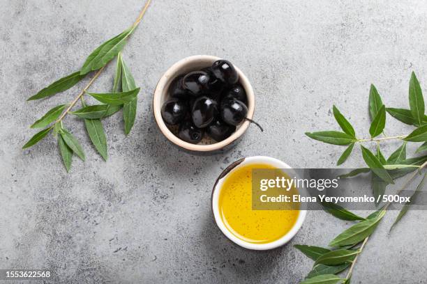 close-up of herbal tea leaves on table - olive oil bowl stock pictures, royalty-free photos & images