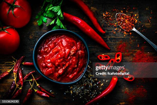 red hot chili sauce with ingredients shot from above on dark wooden table - hot pepper bildbanksfoton och bilder