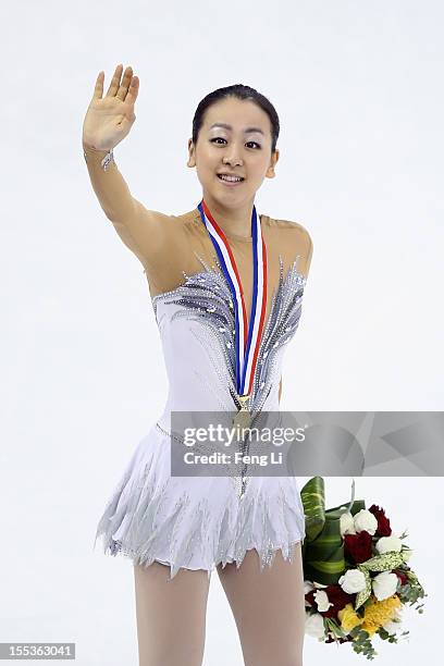 Ladies gold medalist Mao Asada of Japan waves to her fans during the medal ceremony of Cup of China ISU Grand Prix of Figure Skating 2012 at the...