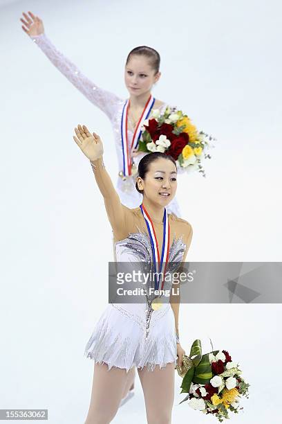 Ladies gold medalist Mao Asada of Japan and silver medalist Julia Lipnitskaia of Russia wave to fans during the medal ceremony of Cup of China ISU...