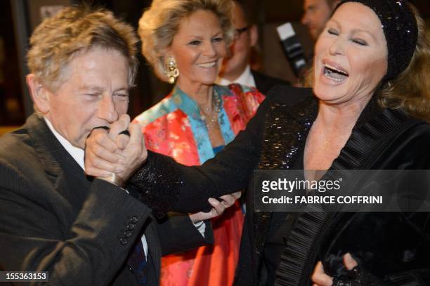 Swiss Hollywood film star Ursula Andress is greeted by Oscar-winning filmmaker Roman Polanski upon their arrival at the Gala de Berne to commemorate...
