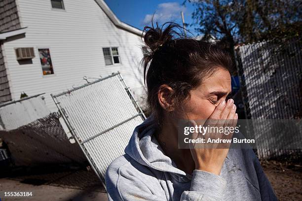 Dr Rosanna Troia breaks down in tears while helping clean out her mother's home in the Midland Beach neighborhood of Staten Island on November 3,...