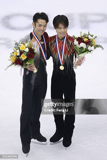 Men gold medalist Tatsuki Machida of Japan and silver medalist Daisuke Takahashi of Japan pose for photo during the medal ceremony of Cup of China...