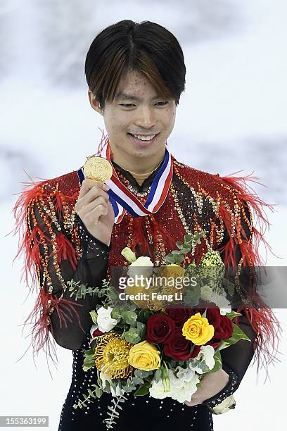 Men gold medalist Tatsuki Machida of Japan poses for photo during the medal ceremony of Cup of China ISU Grand Prix of Figure Skating 2012 at the...