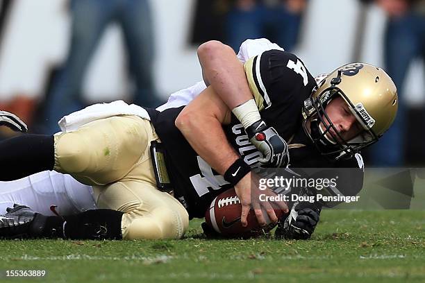 Quarterback Jordan Webb of the Colorado Buffaloes is sacked by inebacker Chase Thomas of the Stanford Cardinal at Folsom Field on November 3, 2012 in...