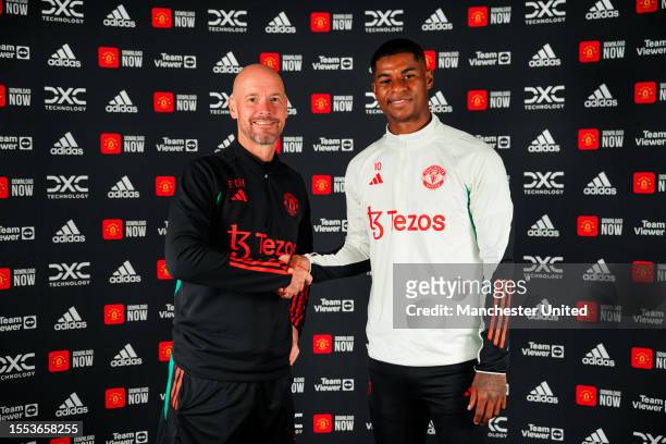 Marcus Rashford of Manchester United poses with Manager Erik ten Hag after signing a new contract extension at Carrington Training Ground on July 18,...