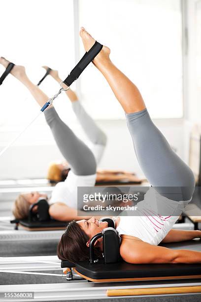 women at the pilates club. - reformer stock pictures, royalty-free photos & images