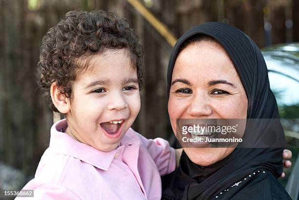 muslim woman with her son - muslim boy stockfoto's en -beelden