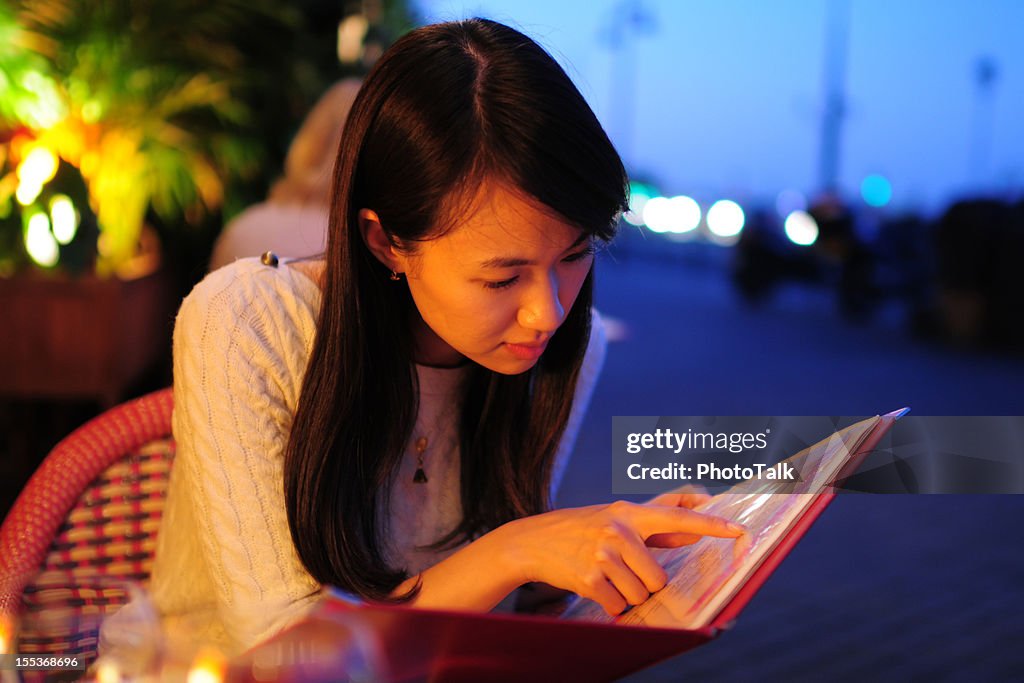 Woman Looking Menu At Restaurant