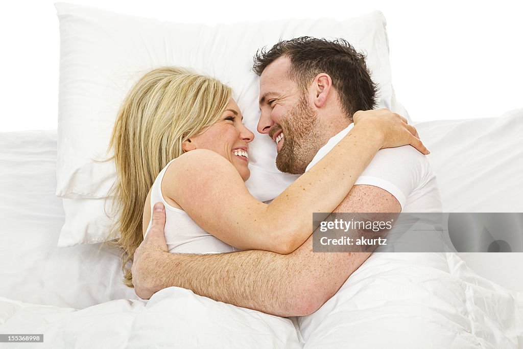 Husband and Wife in bed talking loving each other