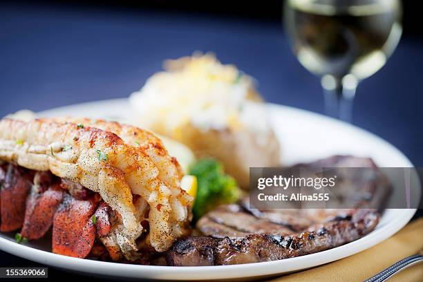 surf and turf: dinner of steak, lobster tail - baked potato stock pictures, royalty-free photos & images