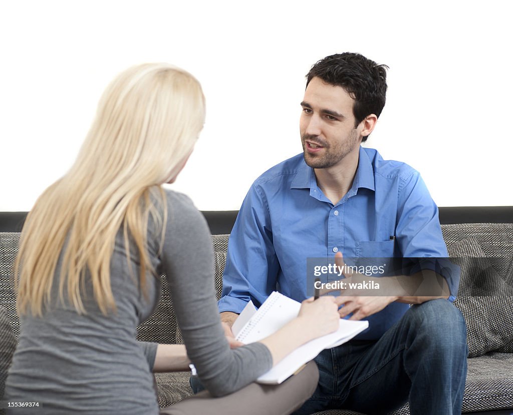 Coach with is debating, coaching about work on a couch