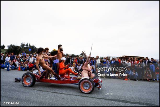Onlookers watch as contestant Eleanor Dickinson drives her 'Model T' as she competes in the second Artists' Soap Box Derby in McLaren Park, San...