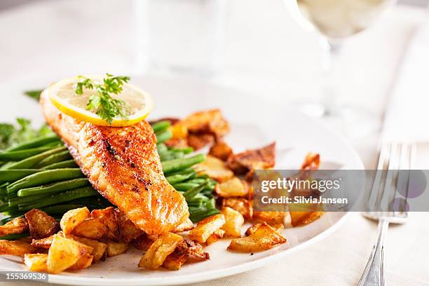 salmon, roast potatoes and vegetables - course meal stock pictures, royalty-free photos & images