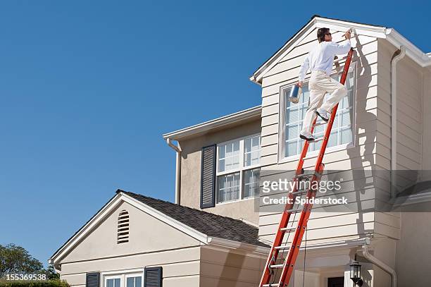 house painter with paint brush - house painting stock pictures, royalty-free photos & images