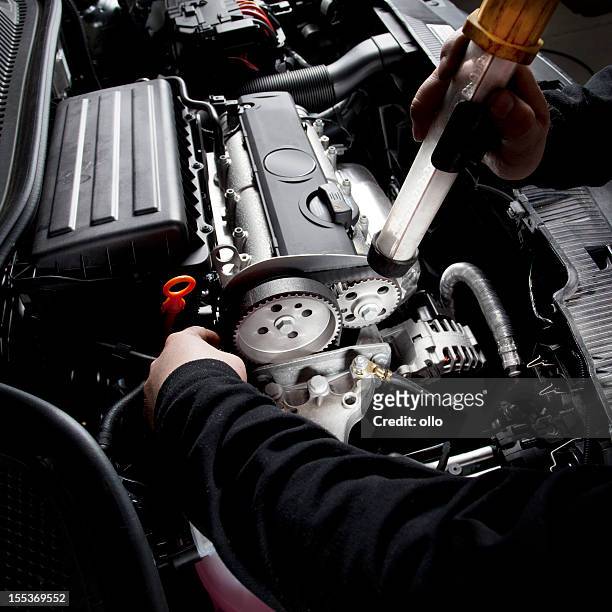 mechanic is checking the timing belt of a modern car - metallic belt stock pictures, royalty-free photos & images