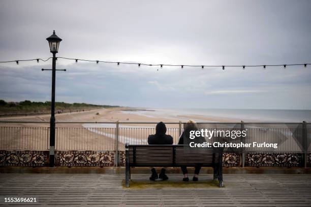 Holidaymakers brave a light shower on Skegness Pier on July 18, 2023 in Skegness, England. As wildfires and a heatwave grip most of Europe the...