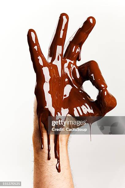 chocolate hand - chocolate melting stock pictures, royalty-free photos & images