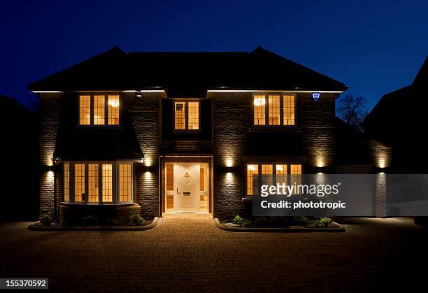 double fronted house at dusk - verlicht stockfoto's en -beelden