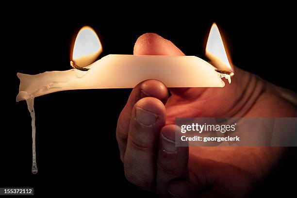 burning the candle at both ends - burning the candle at both ends stock pictures, royalty-free photos & images