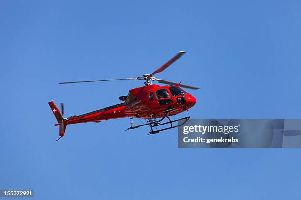 schweizer hubschrauber im flug mit klarem blauem himmel - hubschrauber stock-fotos und bilder