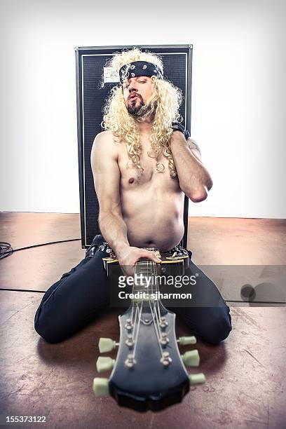 80's curly blond haired rockstar rock star guitar outstretched - man in tight pants stock pictures, royalty-free photos & images