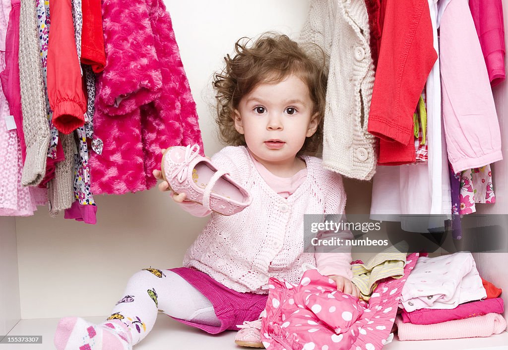 Baby girl choosing her clothes