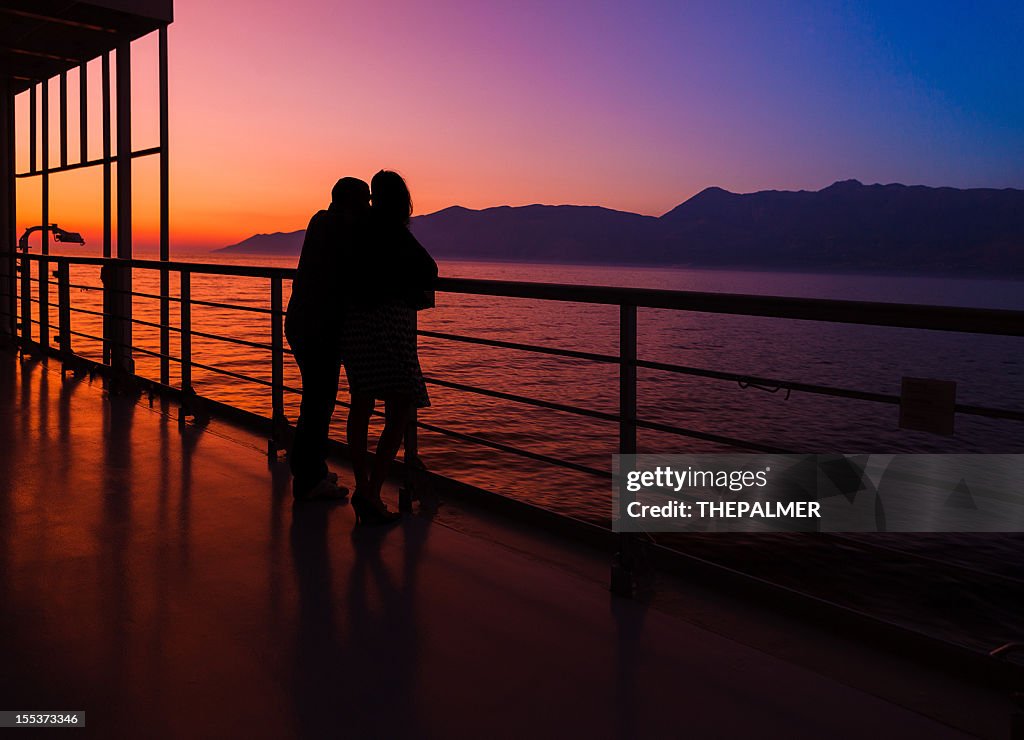 Couple on a cruise ship at sunset