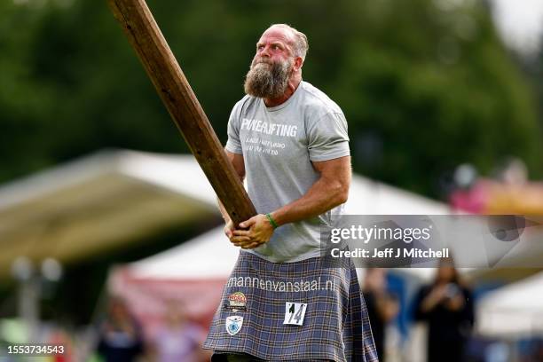 Heavy weight competitors take part in The Caber Toss during the Inveraray Highland Games on July 18, 2023 in Inveraray, Scotland. The games held...