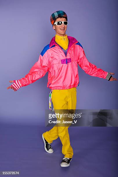 teenager in 1980s fluorescent pink and yellow with cap - funky stockfoto's en -beelden