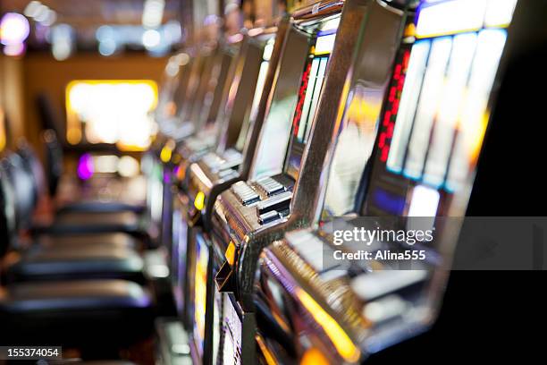 row of  slot machines in a casino - fruit machine stock pictures, royalty-free photos & images