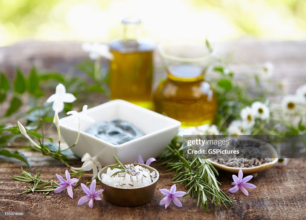Still life of herbs, massage oil, mud mask, rosemary, salt