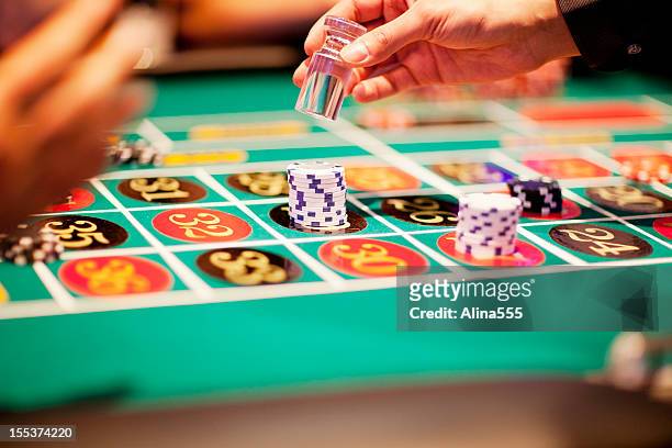 hand of dealer declaring a winner at the roulette table - roulette stock pictures, royalty-free photos & images
