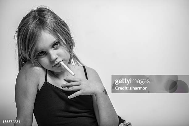 portrait, young girl with cigarette in mouth, looking at camera - emphysema stock pictures, royalty-free photos & images