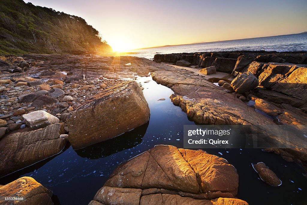 Sunset over coastal rocks