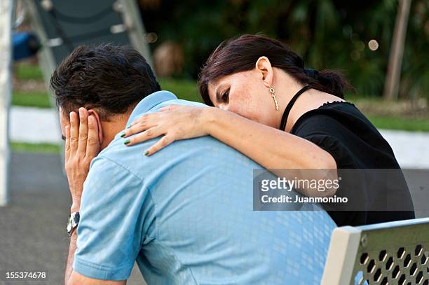 concerned hispanic couple - arm around back stock pictures, royalty-free photos & images