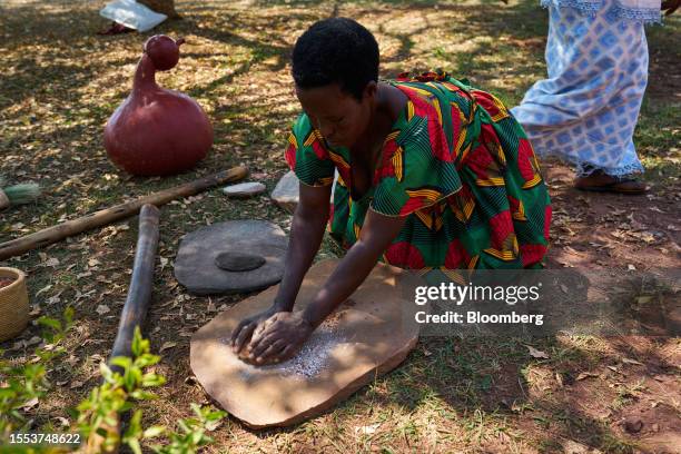 Woman grinds sorghum into flour at the Urugo Women's Opportunity Center in Kayonza, Kayonza District, Eastern Province, Rwanda, on Friday, July 21,...