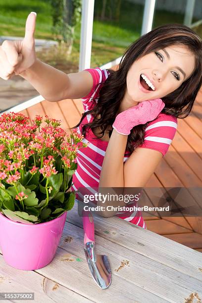 smiling young woman gardening - kalanchoe stock pictures, royalty-free photos & images