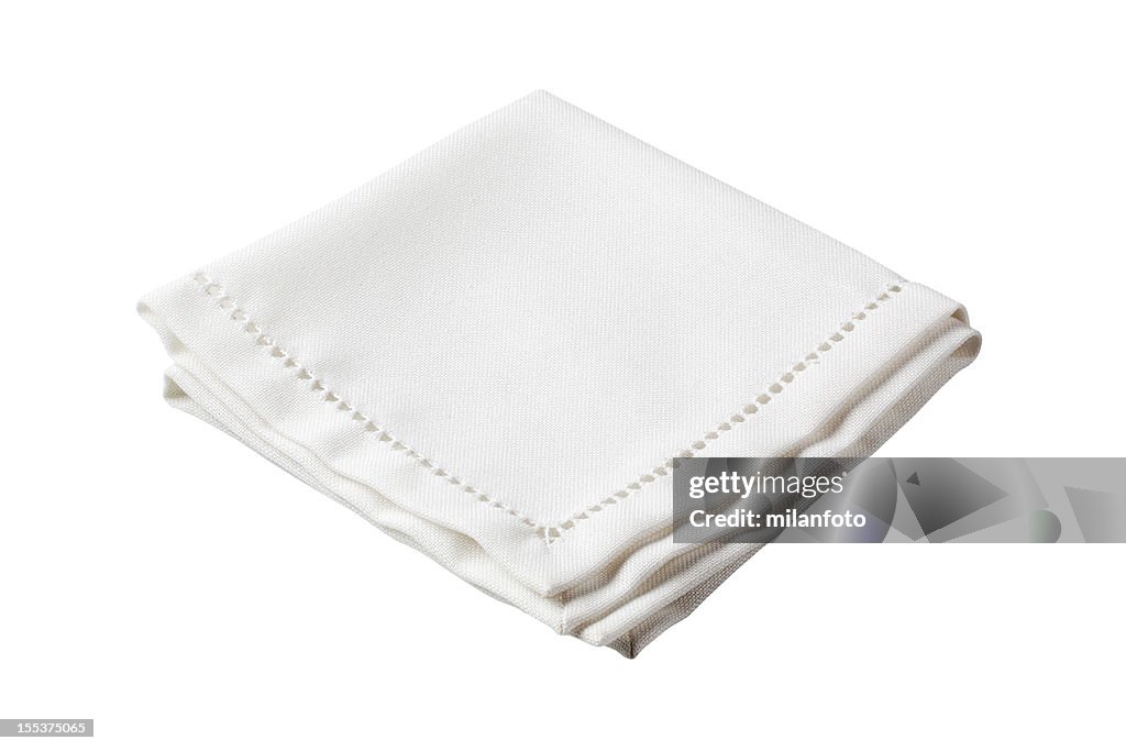 Folded white napkin with embroidered border