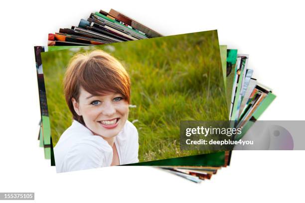 stack of holiday photographs on white - printout stockfoto's en -beelden