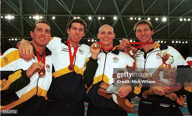 The Australian 4 x 200 metres freestyle relay team of left to right Bill Kirby, Grant Hackett, Michael Klim and Ian Thorpe celebrate setting a new...