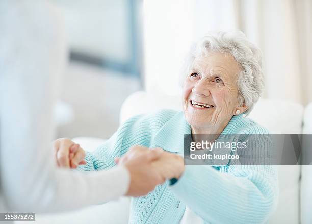 devoted care and assistance - smiling hospital stock pictures, royalty-free photos & images