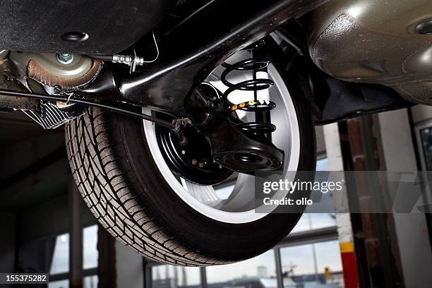 shock absorbers and rear tire of a modern car - shock absorber stock pictures, royalty-free photos & images