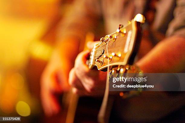 young man playing acoustic guitar in concert - backstage music stock pictures, royalty-free photos & images