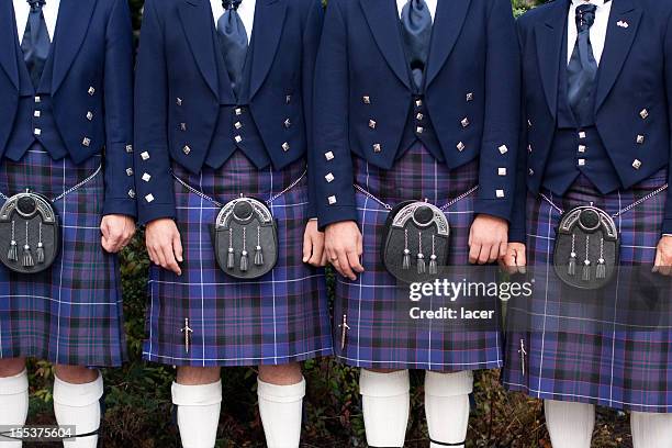 line of men wearing purple kilts - scottish culture stock pictures, royalty-free photos & images